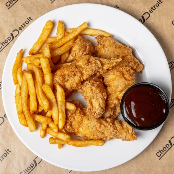 CD Top Shelf chicken tenders and fries with a side of BBQ sauce on a white plate.