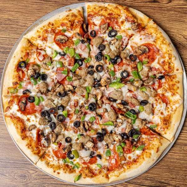 A whole CD Top Shelf pizza, loaded with pepperoni, sausage, mushrooms, olives, and green peppers.